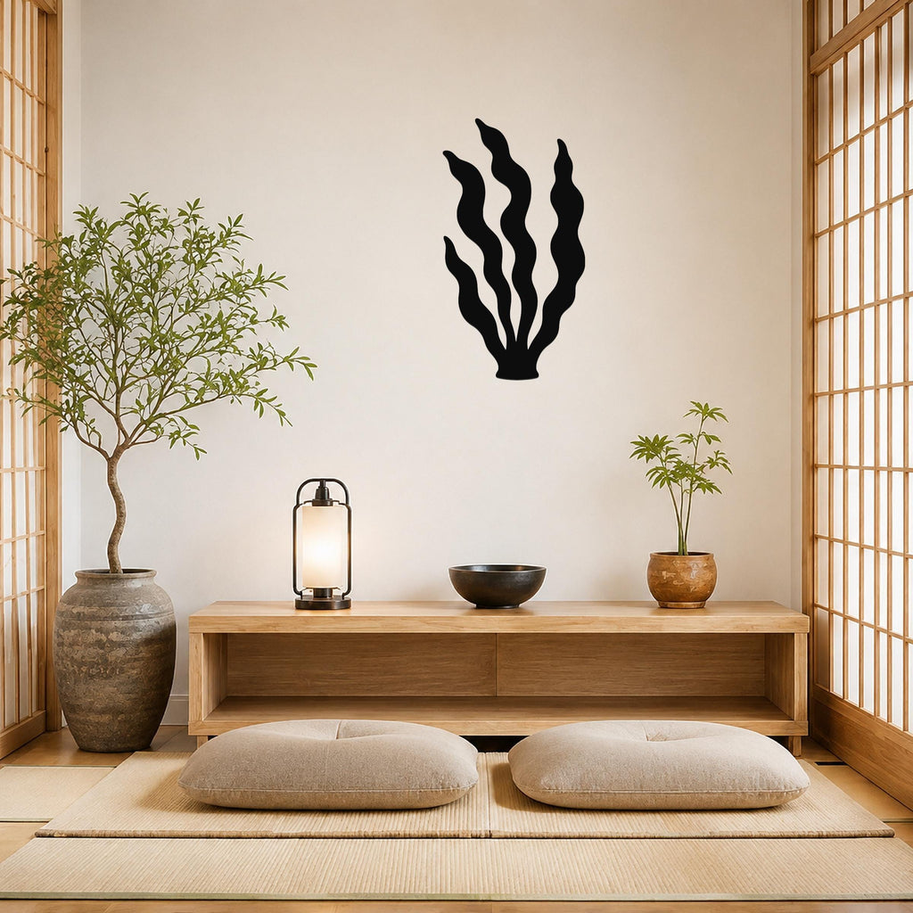 Black metal kelp wall art with wavy blade cutouts, mounted on a beige wall above a wooden console in a minimalist living room.
