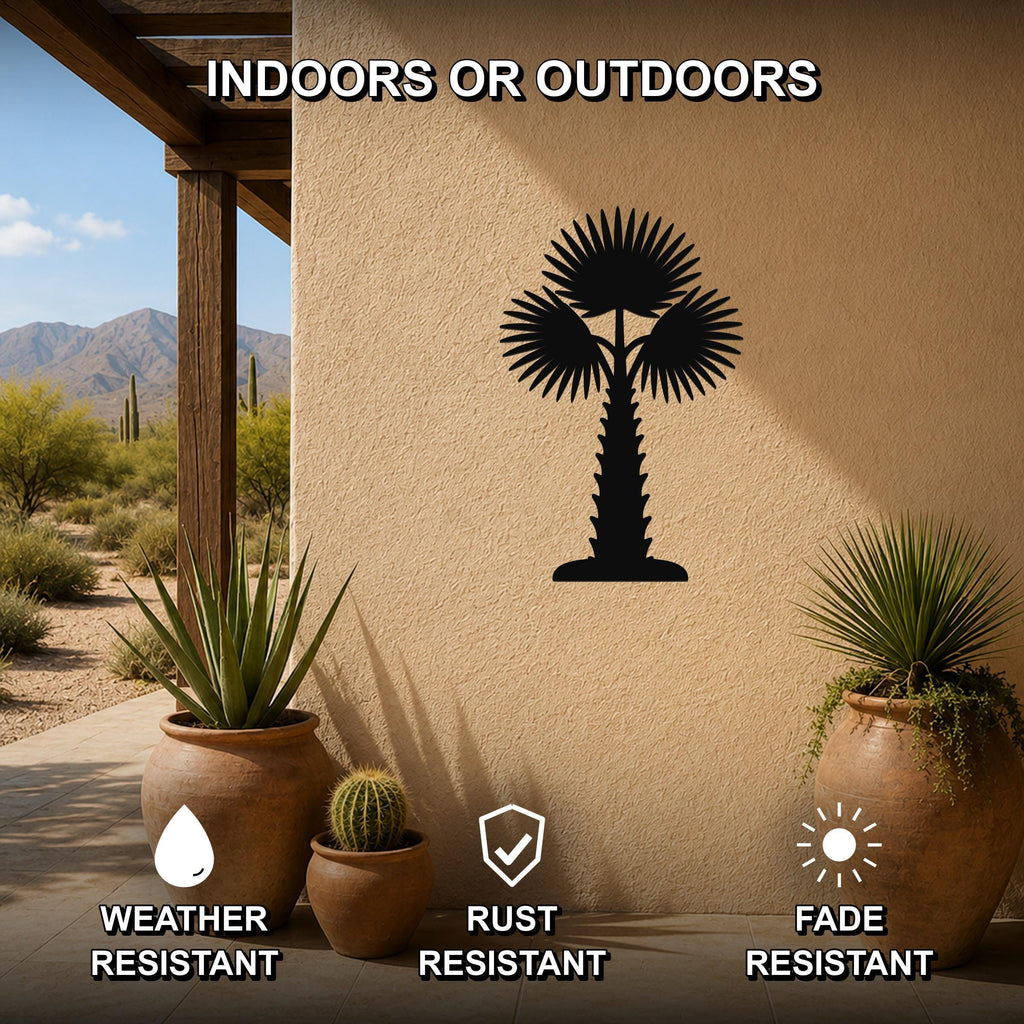 Black metal palm tree wall art with fan-shaped fronds, mounted on an outdoor stucco wall beside potted plants on a patio.