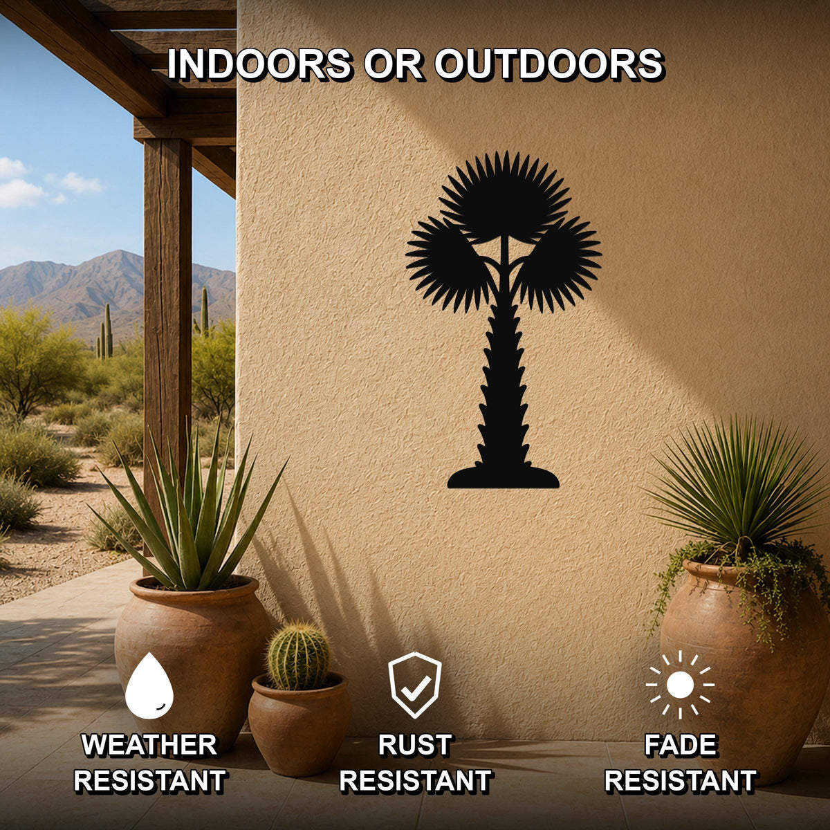 Black metal palm tree wall art with fan-shaped fronds and a textured trunk, mounted on an outdoor stucco wall above potted plants on a patio.