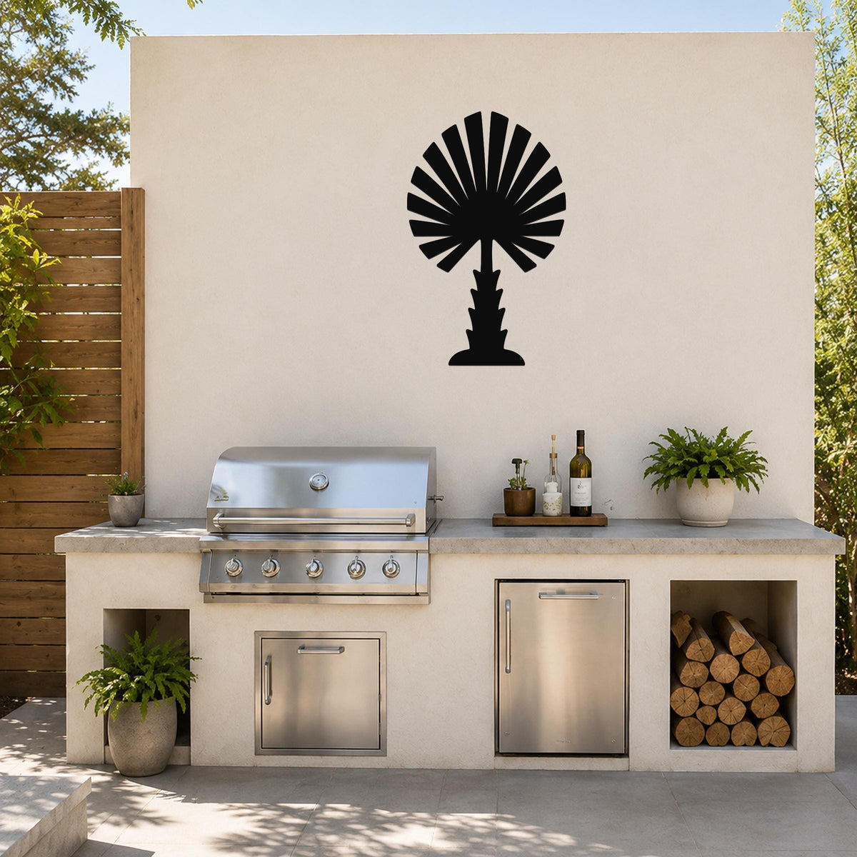 Black metal palm tree wall art with fan-shaped fronds, mounted on an outdoor patio wall above a stainless steel grill and countertop.