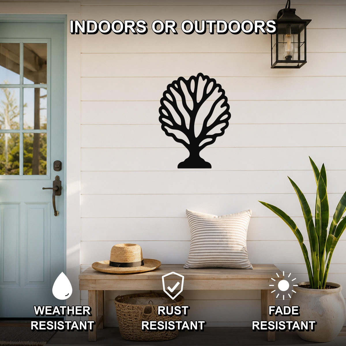 Black metal fan coral wall art with intricate branch cutouts, mounted on a white shiplap wall above a wooden bench on a porch.