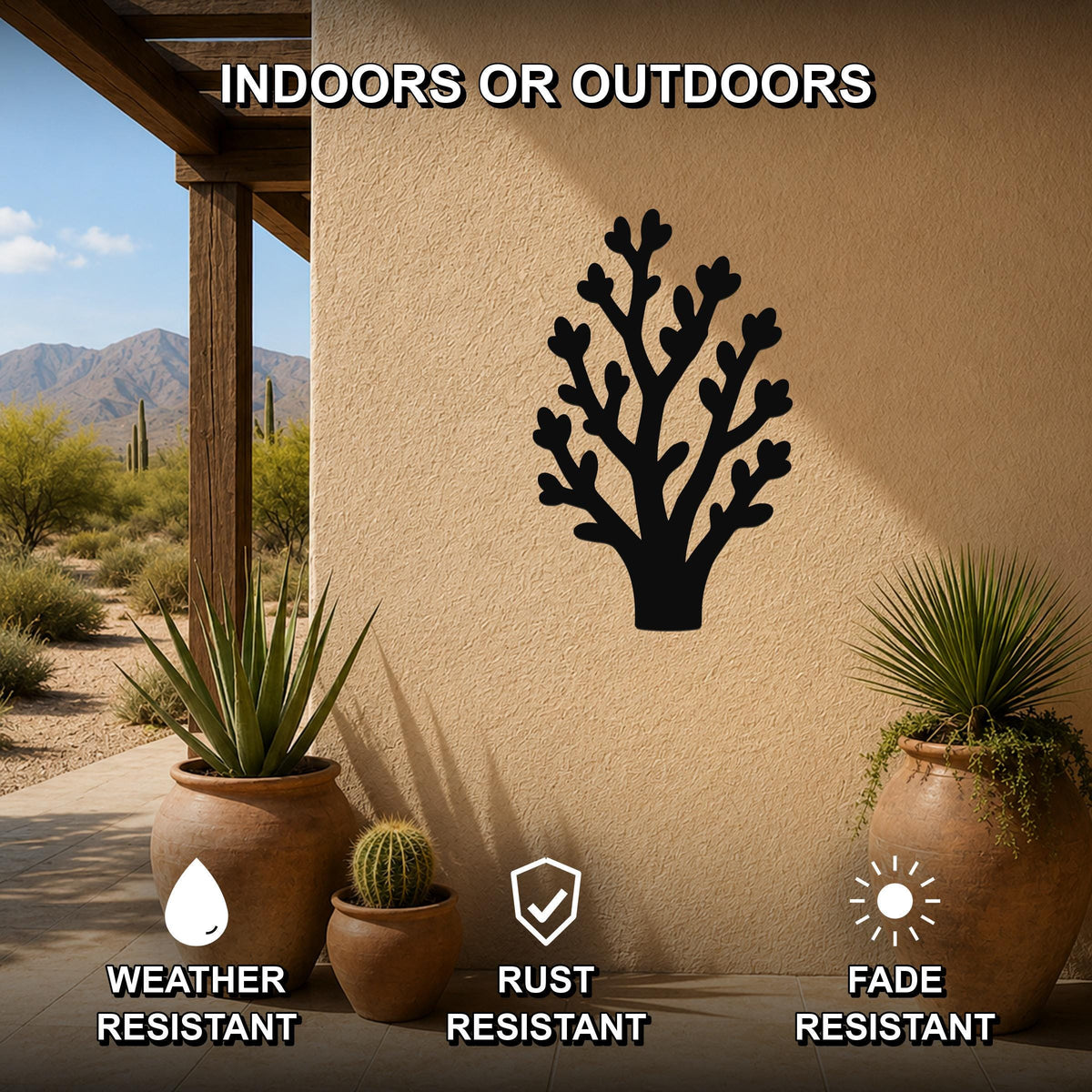 Black metal wall art in a desert branch silhouette, mounted on an outdoor patio wall with potted plants, weather resistant, rust resistant, and fade resistant.