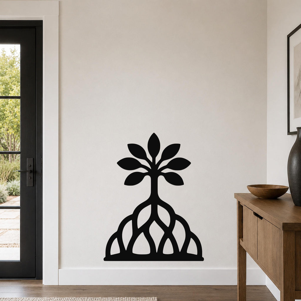 Black metal wall art in a rooted blossom tree silhouette with leaf and root cutouts, mounted on a living room wall above a wooden console table.