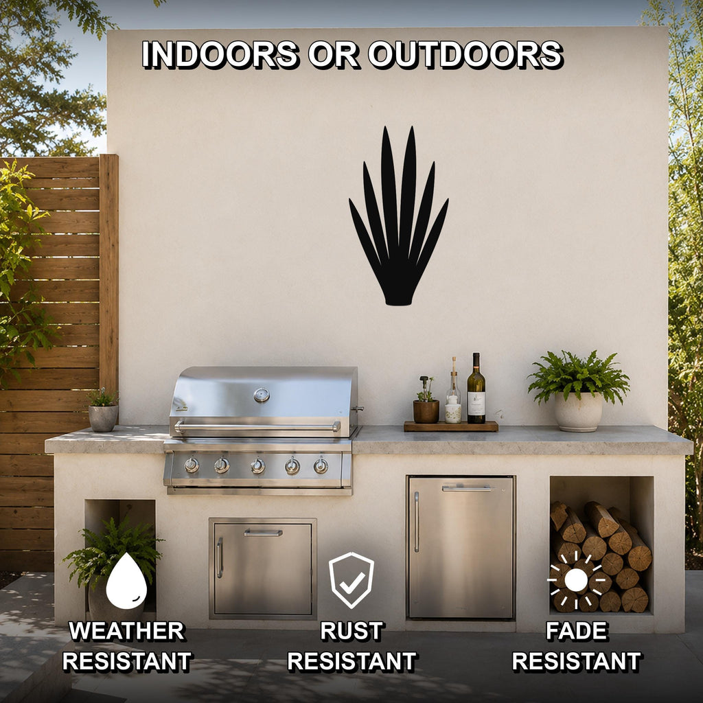 Black metal yucca wall art silhouette mounted on an outdoor patio wall above a stainless steel grill and countertop.