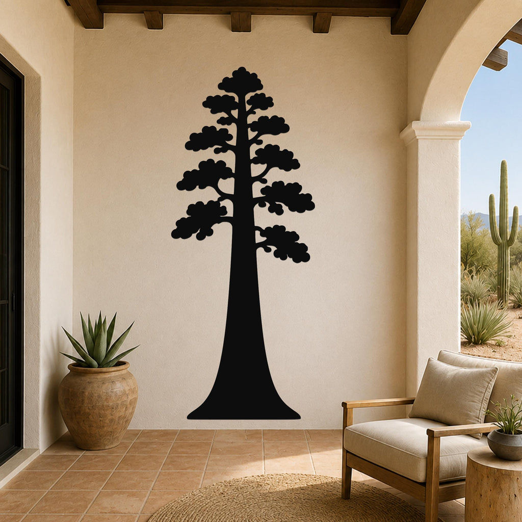 Black metal sequoia tree wall art with layered branch cutouts, mounted on a beige stucco wall in a patio entryway.