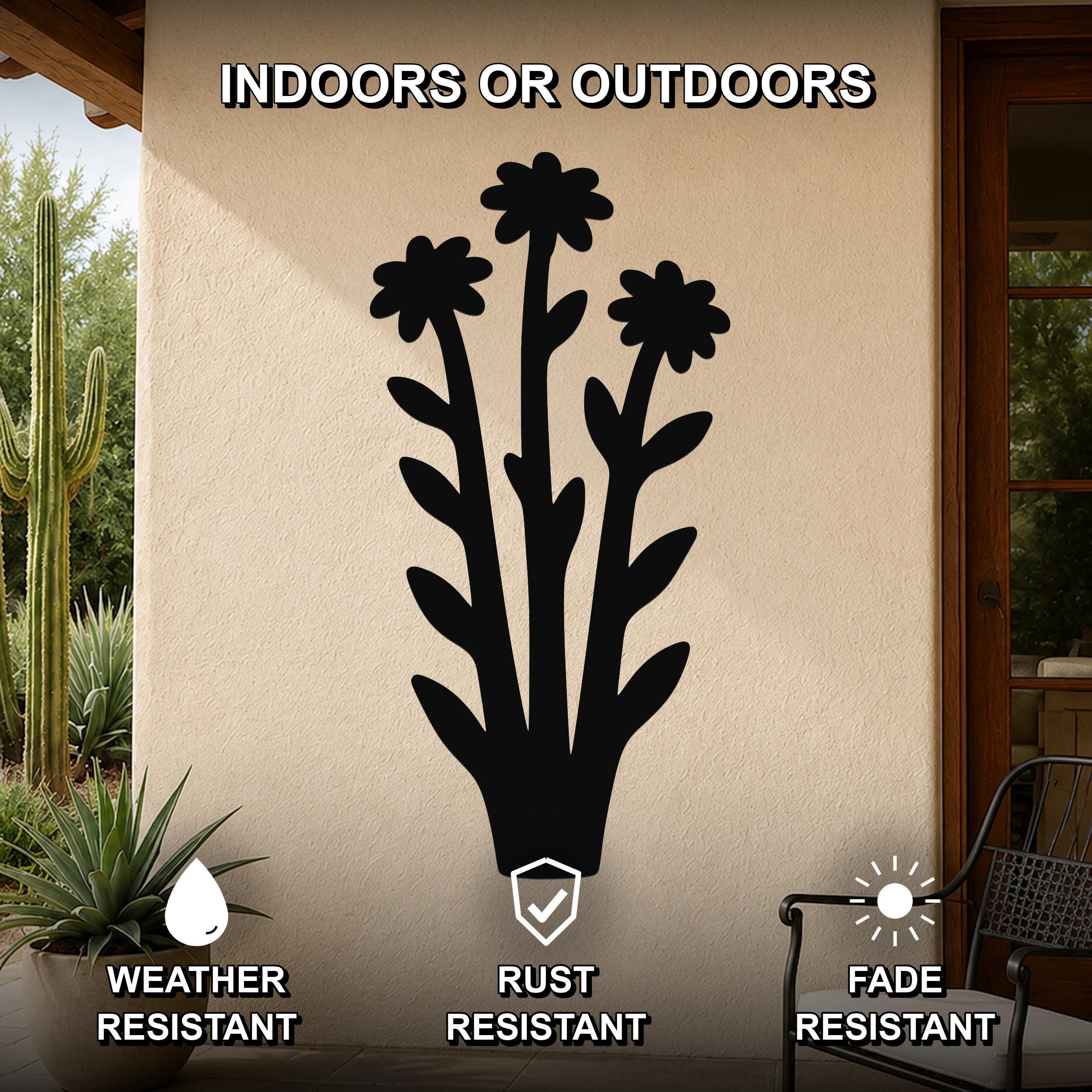Black metal wildflower wall art with three flower cutouts and leafy stems, mounted on an outdoor patio wall, weather, rust, and fade resistant.