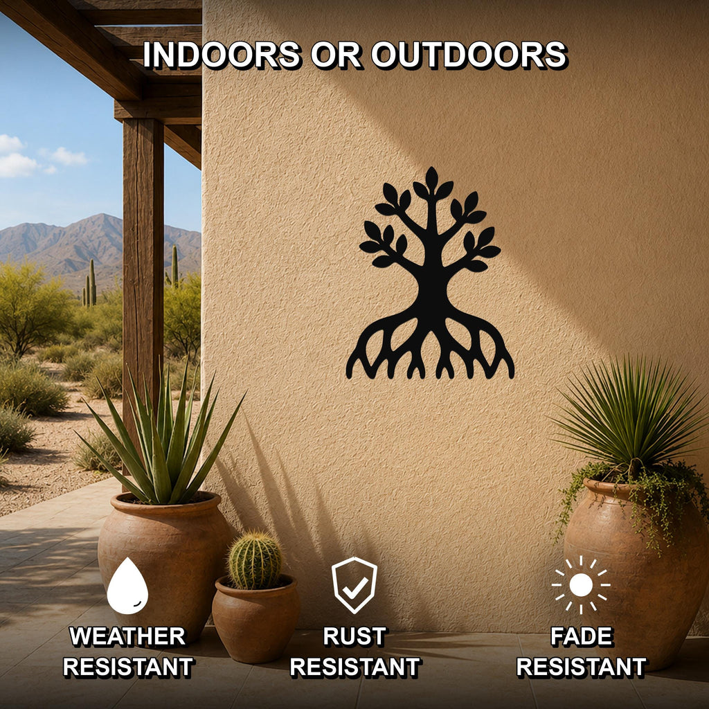 Black metal tree wall art with roots and leaves cutout, mounted on an outdoor stucco wall above potted plants on a patio.