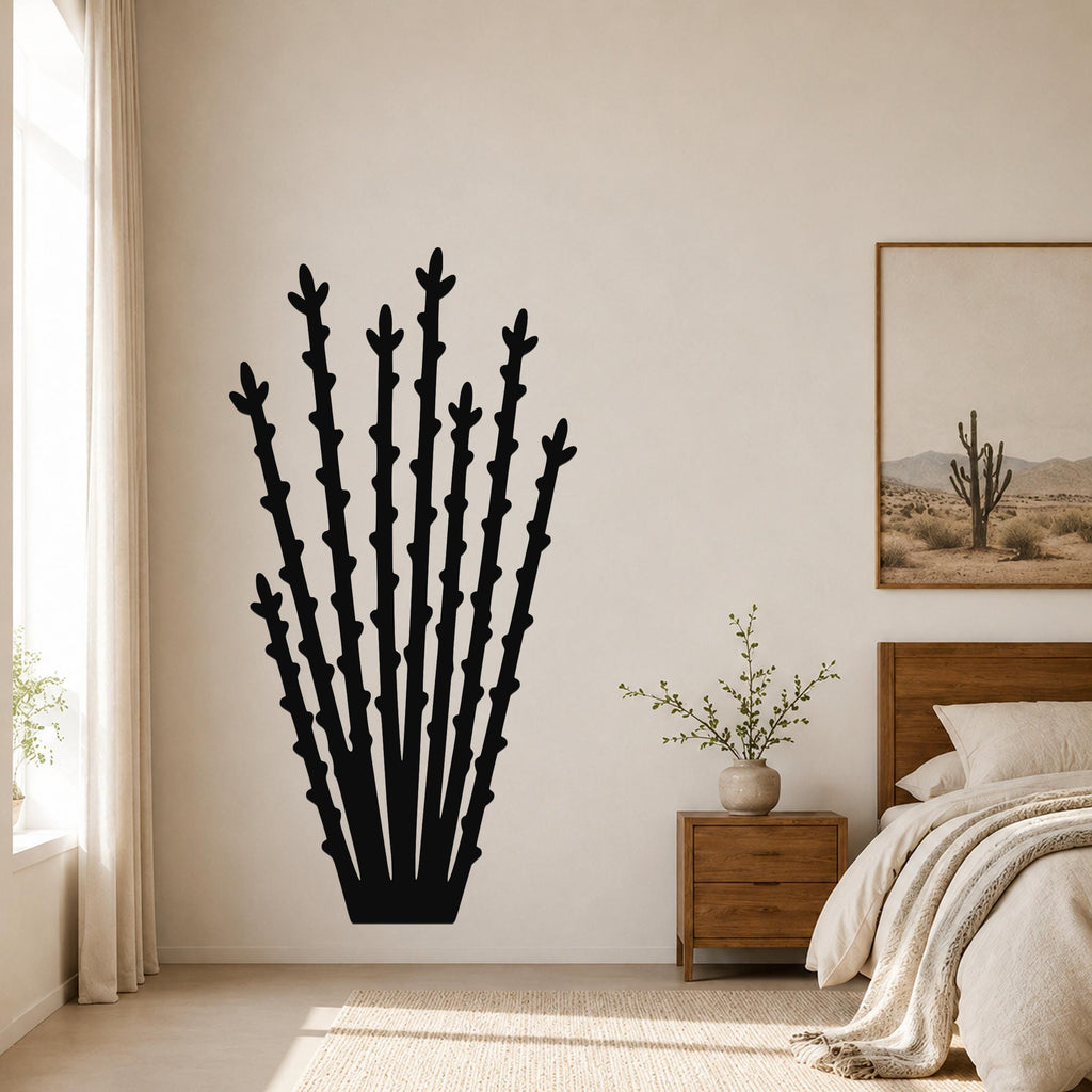 Black metal ocotillo wall art silhouette with multiple spiky stems, mounted on a bedroom wall above a nightstand.