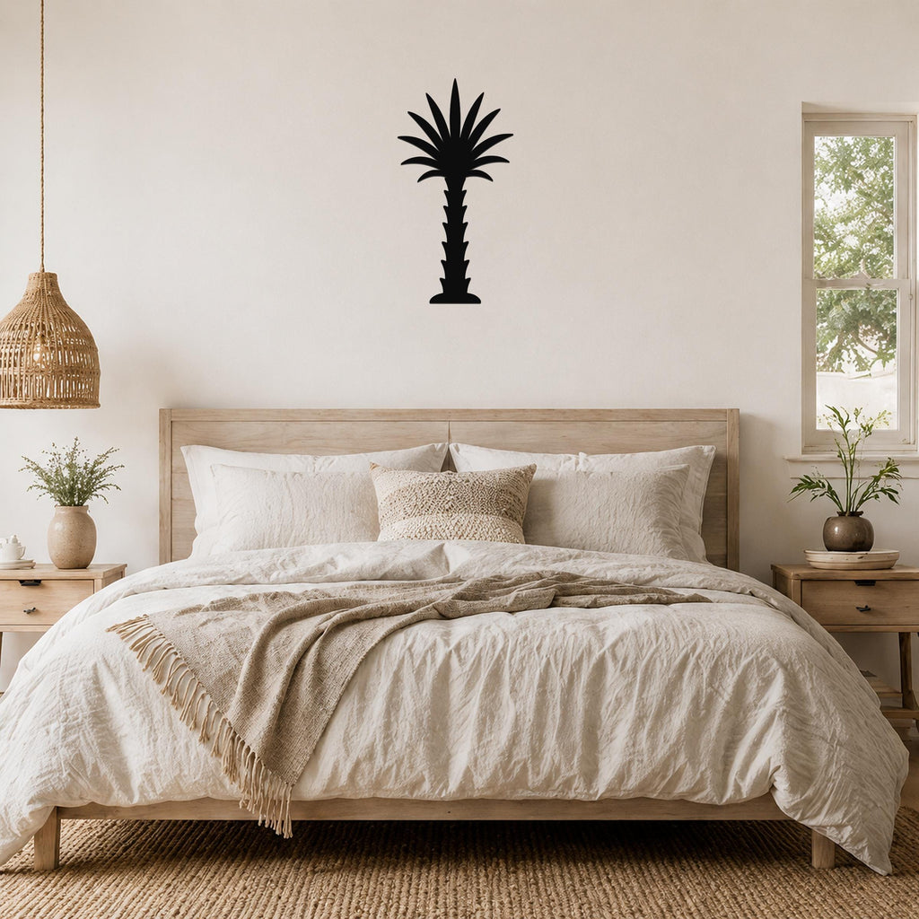 Black metal palm tree wall art silhouette mounted above a wooden bed in a neutral bedroom.