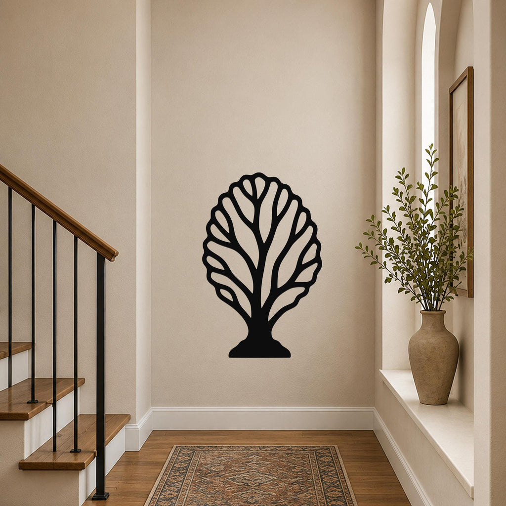 Black metal fan coral wall art with intricate branch cutouts, mounted on a hallway wall above a patterned rug near a staircase.