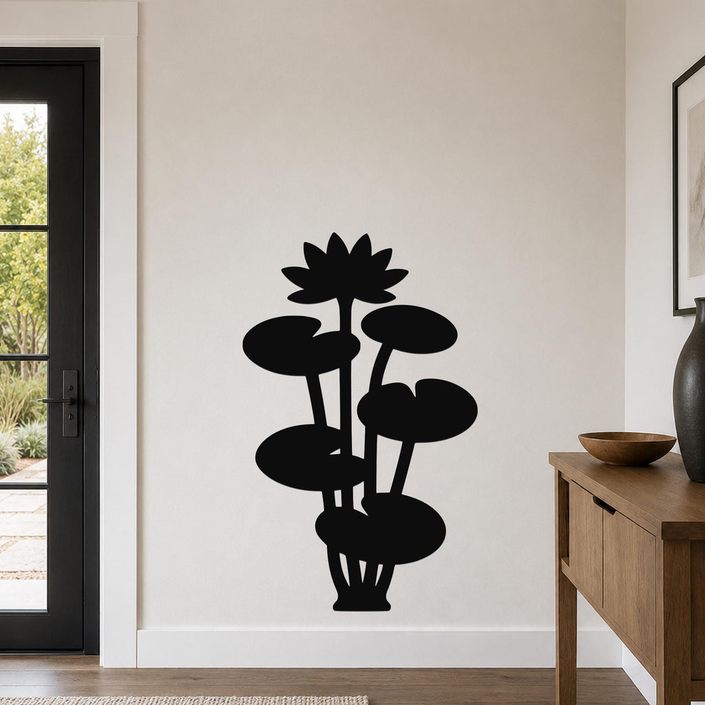 Black metal lotus water lily wall art with a silhouette design of flowers and leaves, mounted on a living room wall above a wooden console table.