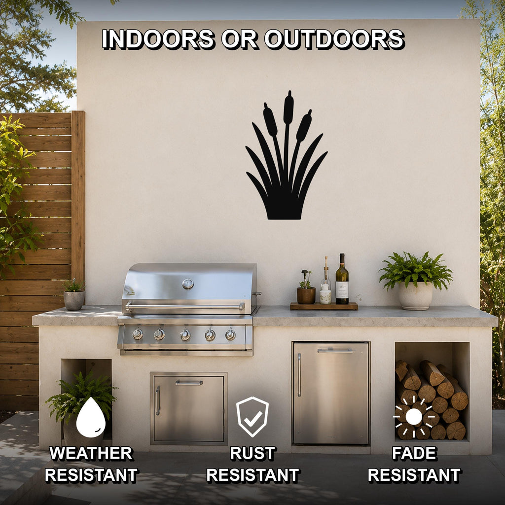 Black metal cattail wall art silhouette mounted on an outdoor patio wall above a stainless steel grill and countertop.