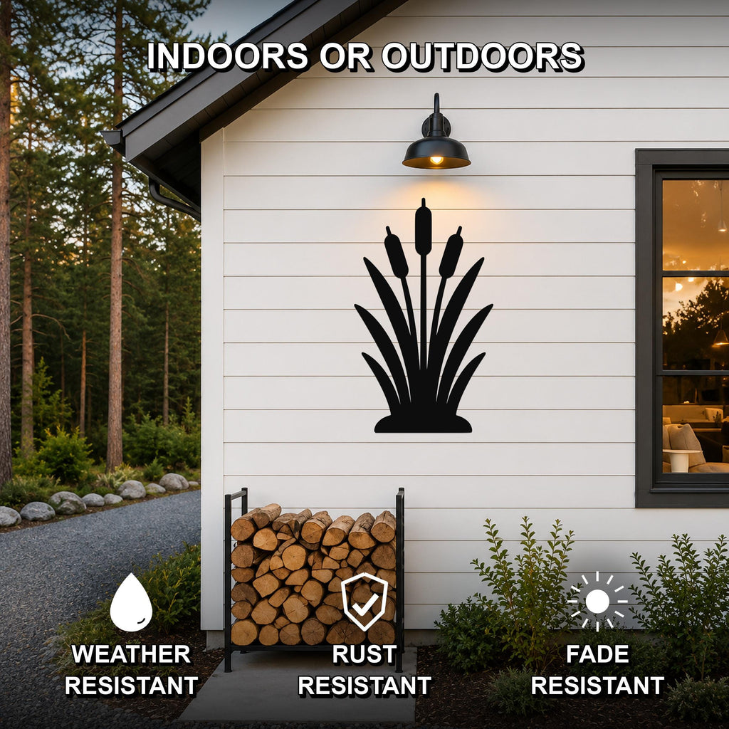 Black metal cattail wall art silhouette mounted on a white exterior wall above a firewood rack, with text indicating it is weather, rust, and fade resistant for indoor or outdoor use.