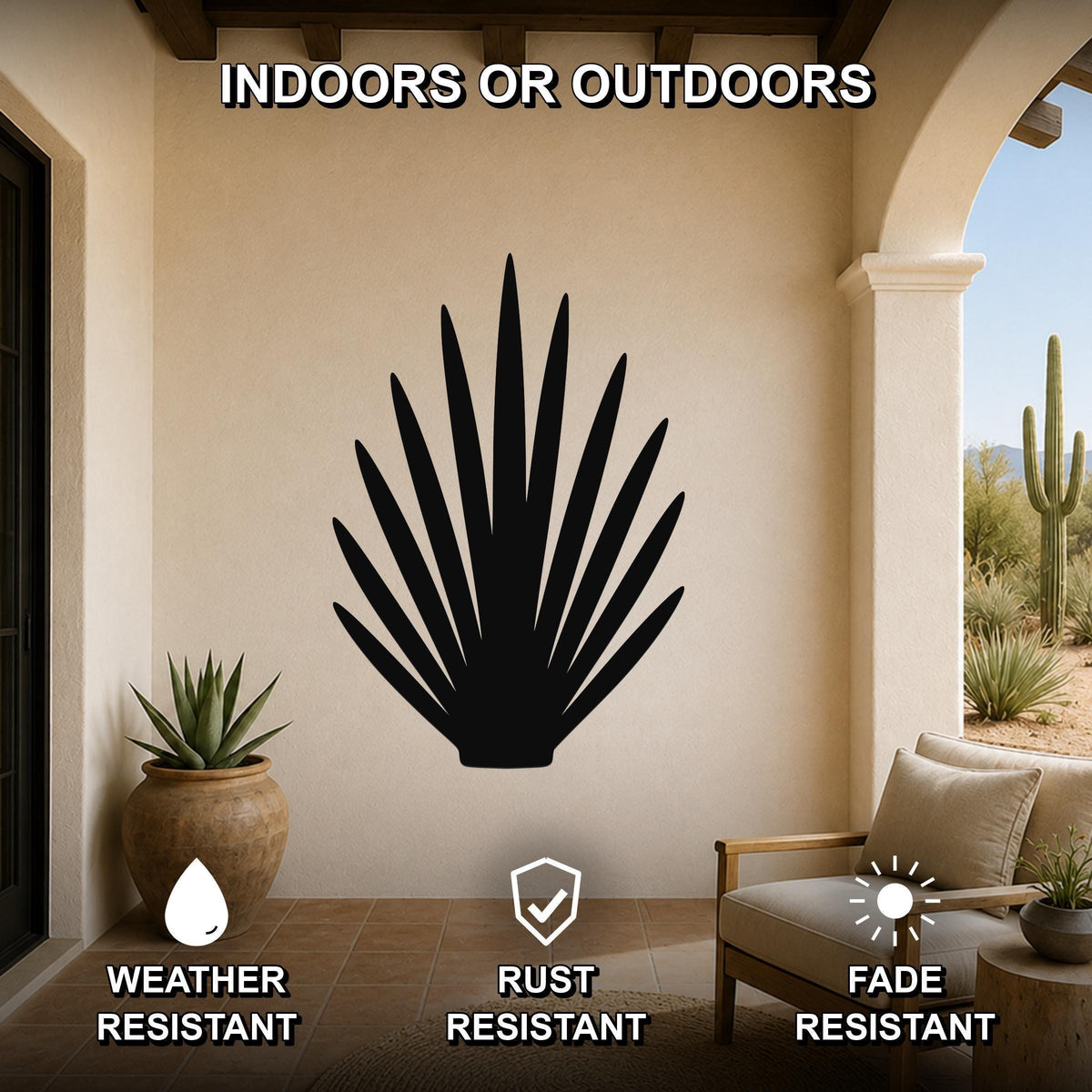 Black metal agave plant wall art with spiky leaf cutouts, mounted on a beige outdoor patio wall above a wooden chair.