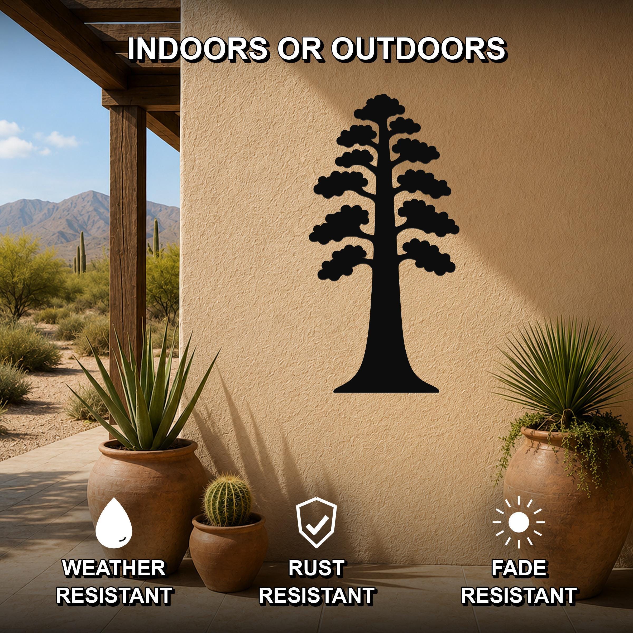 Black metal sequoia tree wall art with layered branch cutouts, mounted on an outdoor stucco wall beside potted plants on a patio.