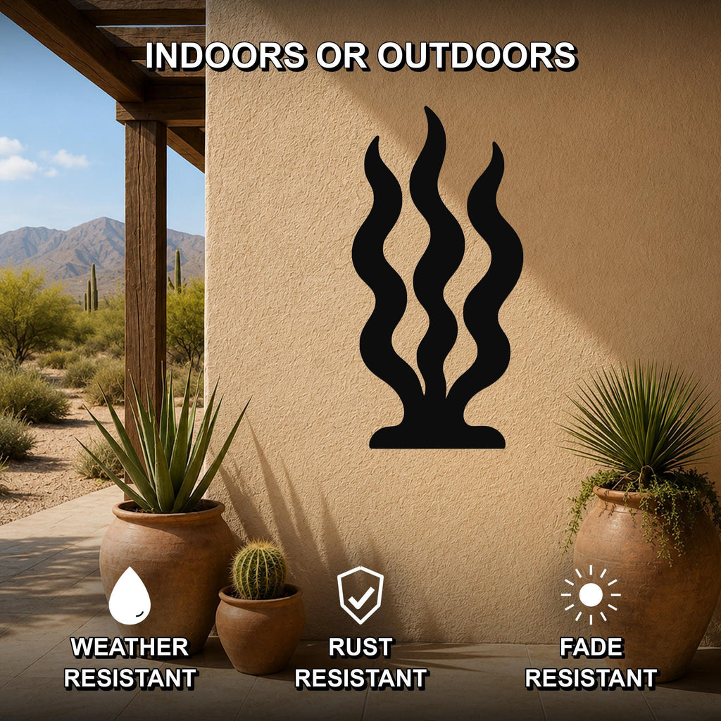 Black metal wall art with wavy grass silhouette, mounted on an outdoor patio wall above potted plants, weather resistant, rust resistant, and fade resistant.