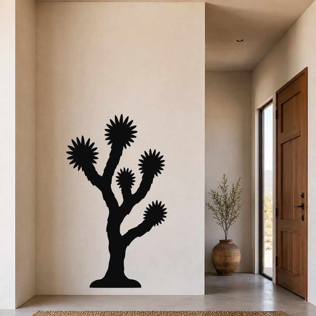 Black metal Joshua tree wall art with starburst-shaped branches, mounted on a beige wall in a modern entryway.
